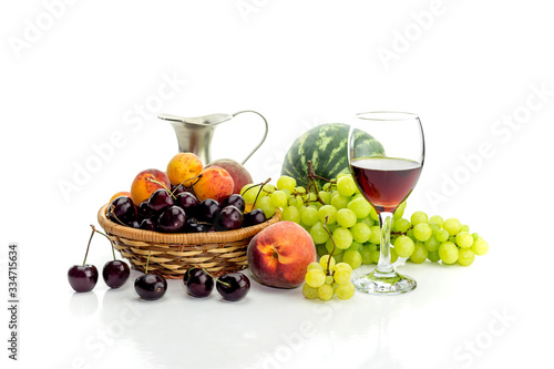 Summer fruit and jug of wine on a white background close-up
