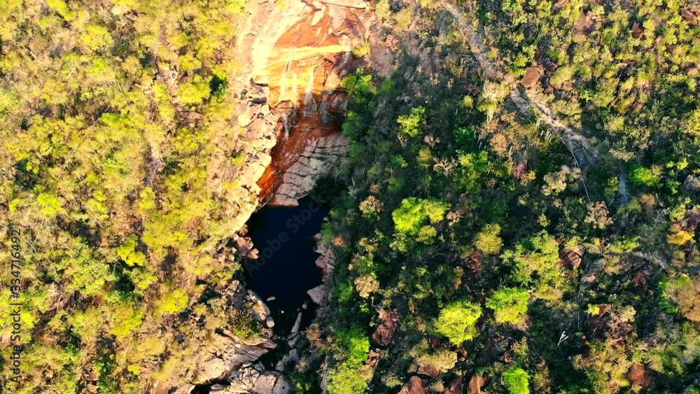 Majestic aerial shot of Cachoeira do Riachinho waterfall and environing caatinga landscape at Vale do Capao, Bahia, Brazil. Drone Slowly moving up Majestic aerial shot of Cachoeira do Riachinho waterfall and environing caatinga landscape at Vale do Capao, Bahia, Brazil. Drone Slowly moving up