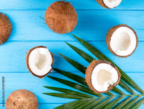 Coconuts with palm leaves on wooden table