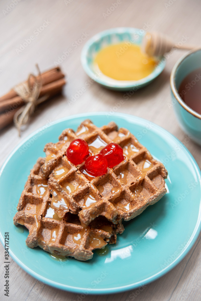 Healthy breakfast waffles with honey and coctail cherries Healthy breakfast waffles with honey and coctail cherries