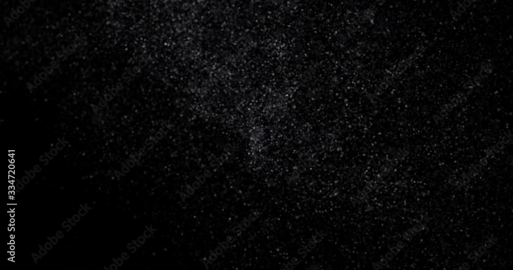 Flying dust particles on a black background Flying dust particles on a black background