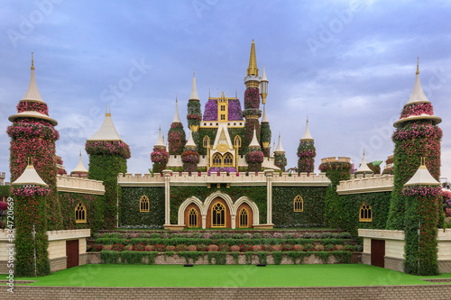Canvas Print Big palace made of green grass and flowers in Miracle Garden