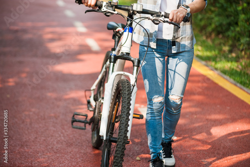 Fototapeta Naklejka Na Ścianę i Meble -  Woman cyclist riding mountain bike in park