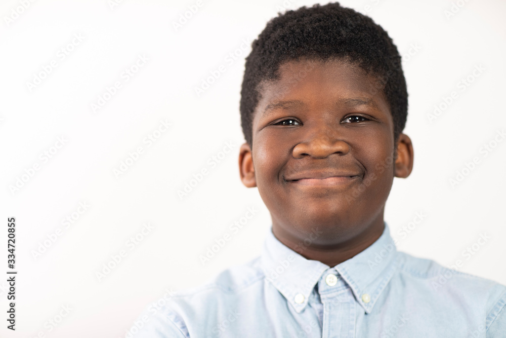 Head and Shoulders Studio Portrait Of Smiling Boy Against White Background Head and Shoulders Studio Portrait Of Smiling Boy Against White Background