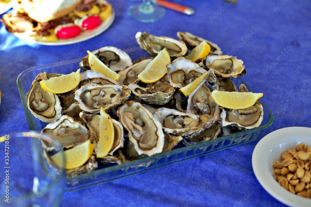 Oysters with lemon on a table blue background.from Nantes france Oysters with lemon on a table blue background.from Nantes france