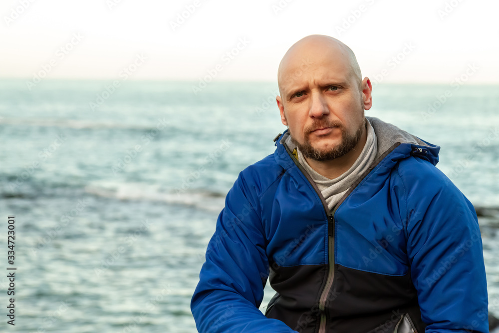 Portrait of a bald man on the sea coast Portrait of a bald man on the sea coast