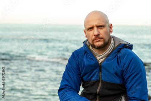Portrait of a bald man on the sea coast