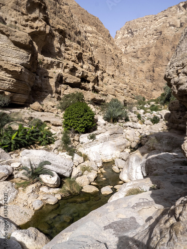 Wadi Shab, beautiful scenery, high rocks, stream with clear water. Oman