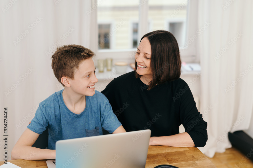 Young teenage boy smiling at his mother Young teenage boy smiling at his mother
