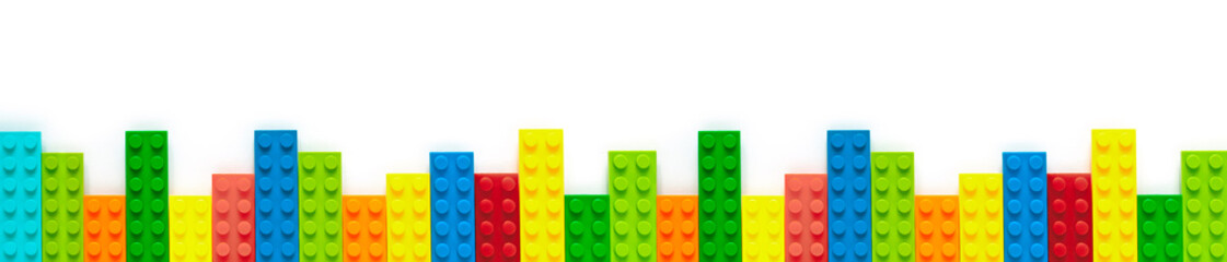 Colored toy bricks on white background