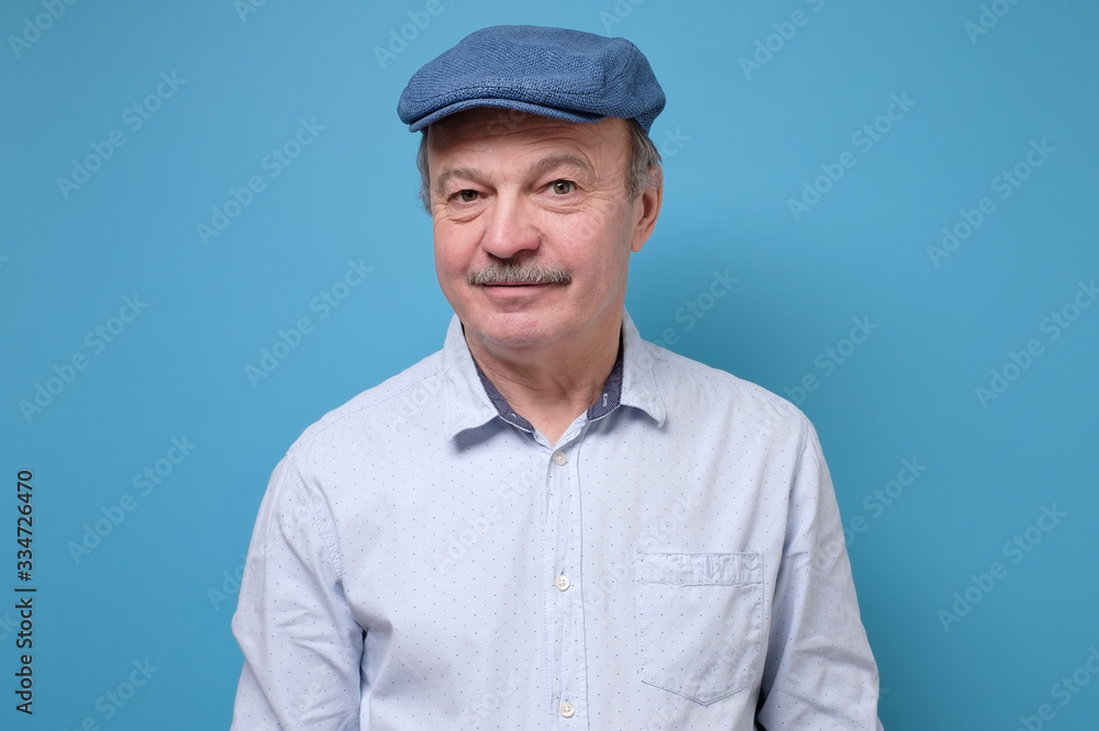 Portrait of a smiling and confident senior good looking business man with hat Portrait of a smiling and confident senior good looking business man with hat