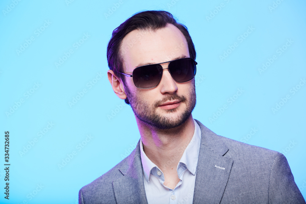 Studio portrait of handsome elegant young man in grey jacket Studio portrait of handsome elegant young man in grey jacket