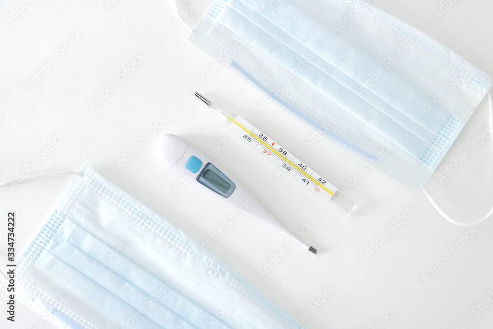 Two thermometers between face masks Two thermometers between face masks