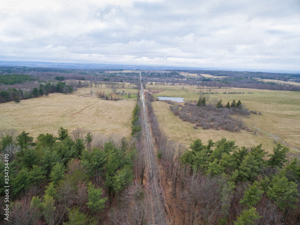 Obraz premium aerial view of Road in field and forest 
