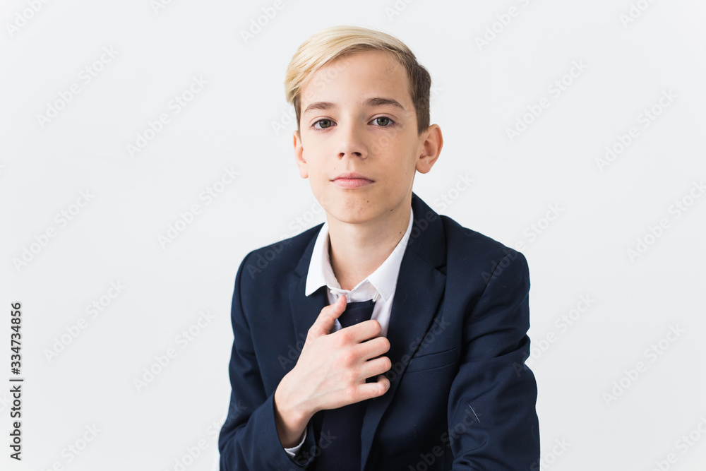 Portrait of stylish school boy teenager in white shirt and jacket against white background. Portrait of stylish school boy teenager in white shirt and jacket against white background.