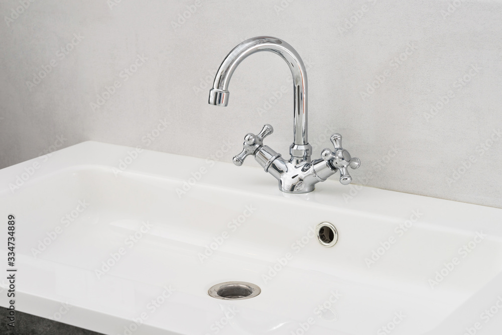 Fototapeta premium Bathroom interior with white sink and chrome faucet.