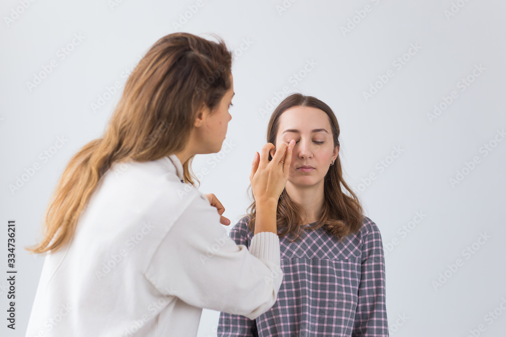 Beauty and cosmetics concept - Makeup artist doing professional make up of young woman Beauty and cosmetics concept - Makeup artist doing professional make up of young woman