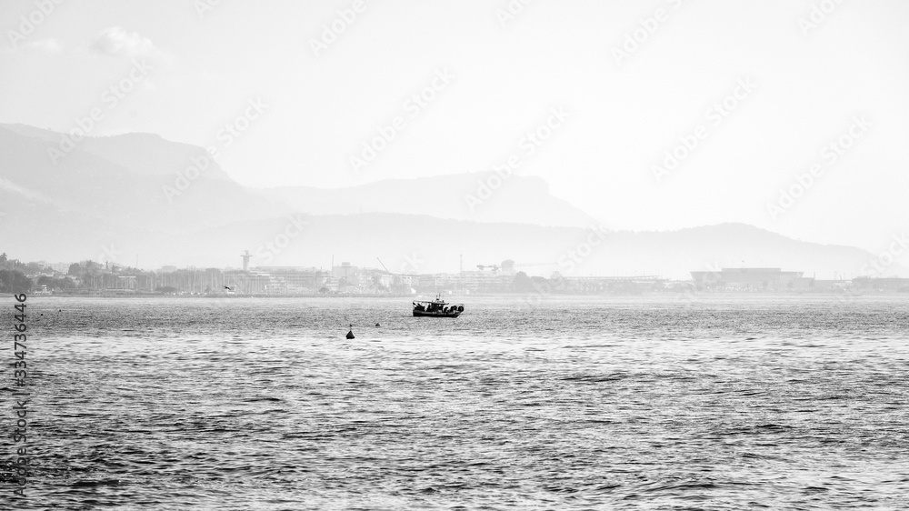 Fisherman between sea and mountain