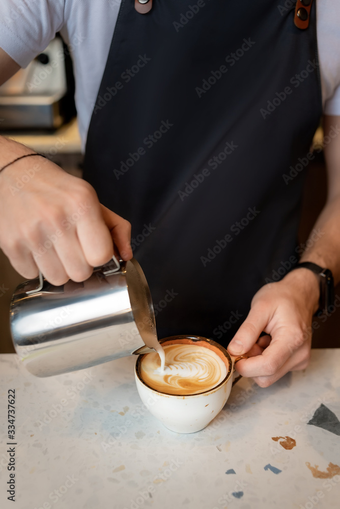 bartender is preparing a cappuccino in a cafe bartender is preparing a cappuccino in a cafe