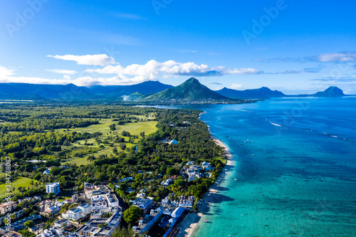 The beach at Flic en Flac with luxury hotels and palm trees, behind the mountain Tourelle du Tamarin, Mauritius, Africa photo