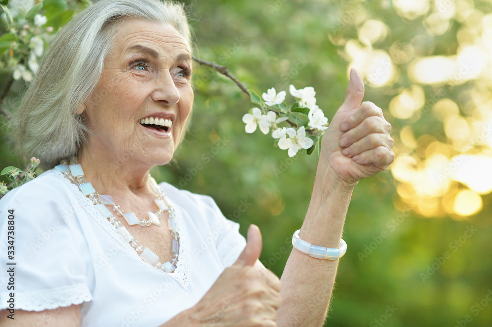 Portrait of happy senior beautiful woman in spring park Portrait of happy senior beautiful woman in spring park