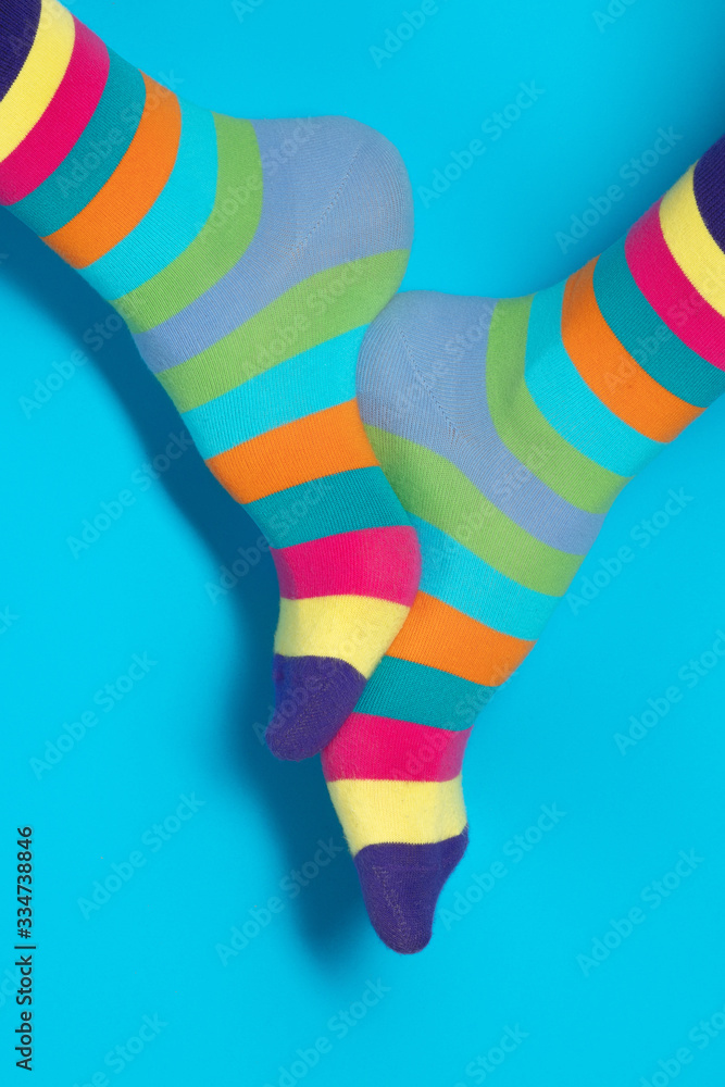 Man with rainbow socks on color background. Man with rainbow socks on color background.