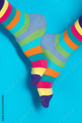 Man with rainbow socks on color background. 