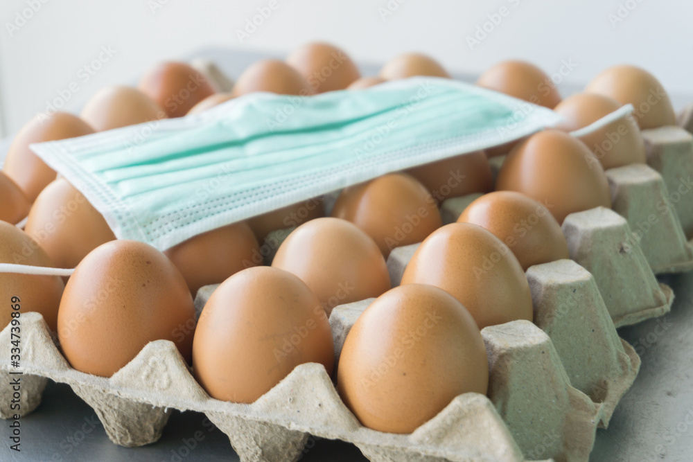 Sanitary mask placed on the egg tray, Corona virus crisis. Sanitary mask placed on the egg tray, Corona virus crisis.