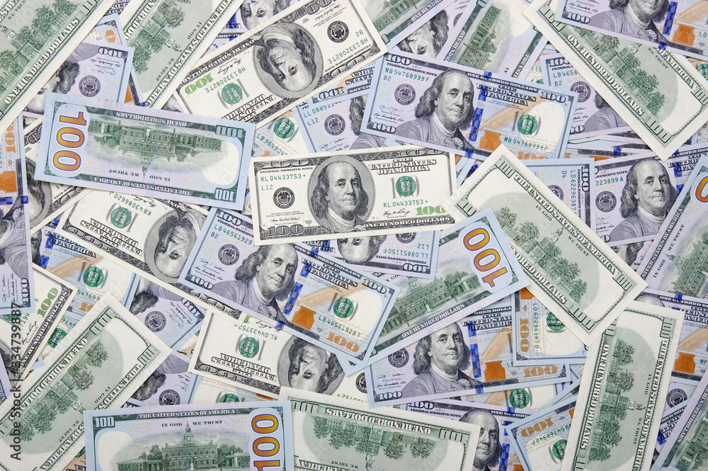 Heap of one hundred dollar bills on money Heap of one hundred dollar bills on money
