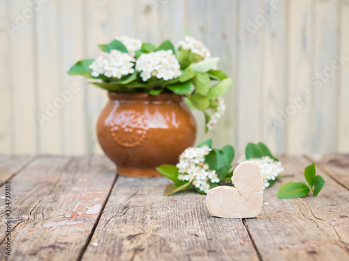 Vintage floral background. Aronia Flowers. Chokeberries flower on wooden table