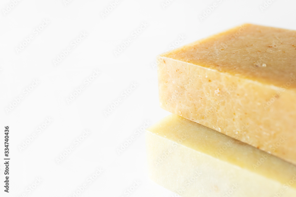 Close-up handmade soap bar with selective focus on white background. Organic handcraft health care, body care and hygiene product Close-up handmade soap bar with selective focus on white background. Organic handcraft health care, body care and hygiene product