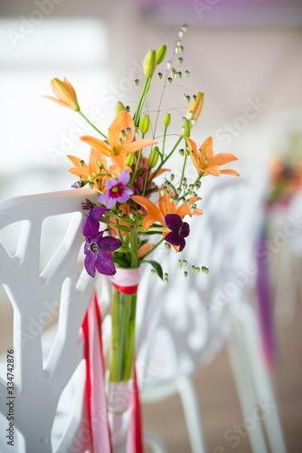 weddingflower arrangement in orange, pink and purple photo