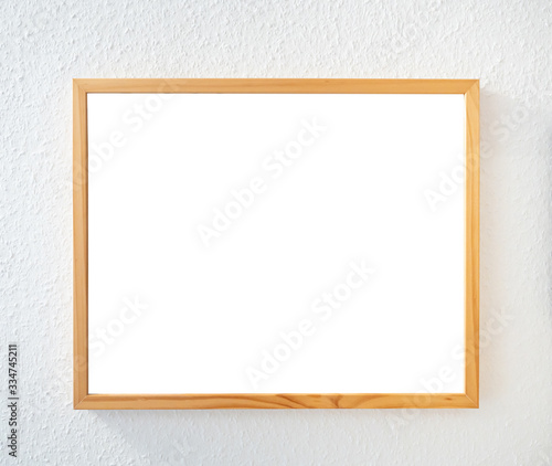 wooden picture frame on white wallpaper