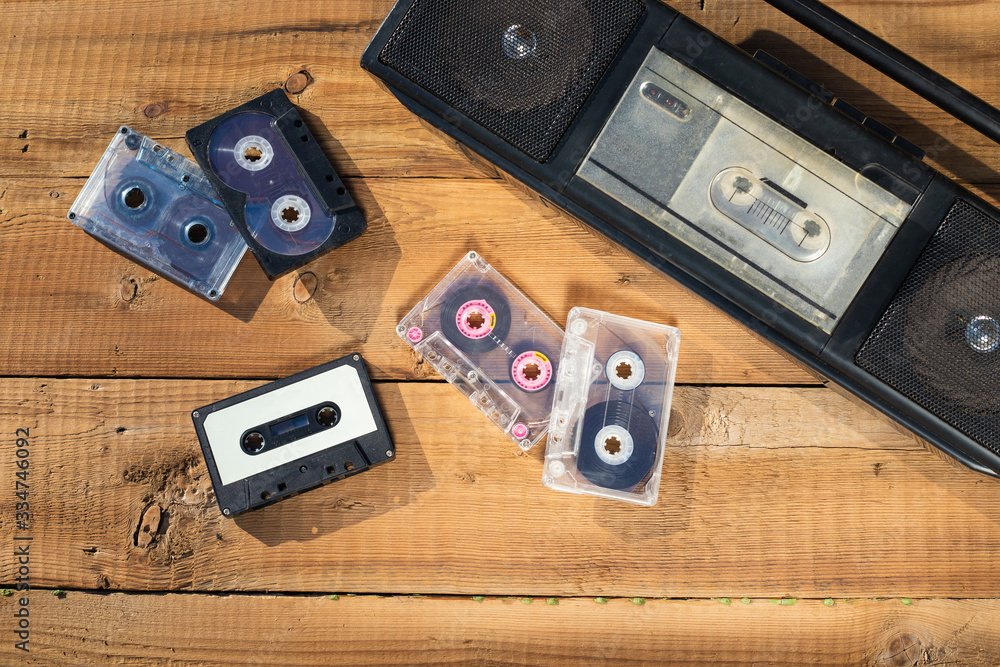 tape recorder with retro tape cassette on a wooden background tape recorder with retro tape cassette on a wooden background