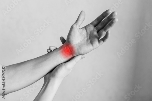 Joint and elbow injuries, fatigue at work. Area of the injury, the image on a clean background. Spasm on the man's wrist. photo