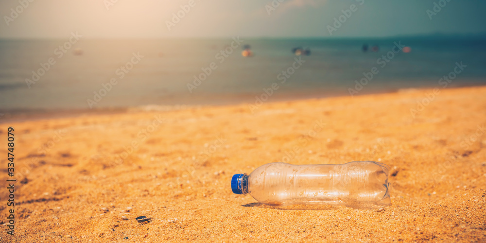 Water bottle or garbage on beach of sea with the backdrop of the sea and light of the sun. Water bottle or garbage on beach of sea with the backdrop of the sea and light of the sun.