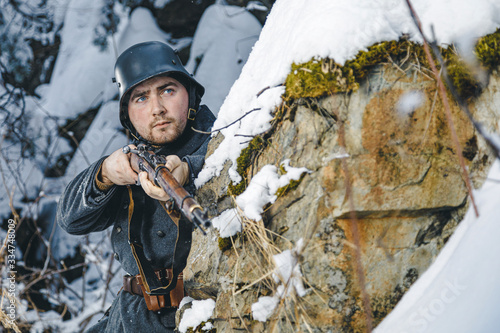 Soldier with a rifle in winter. Historical reenactment of Finnish army photo