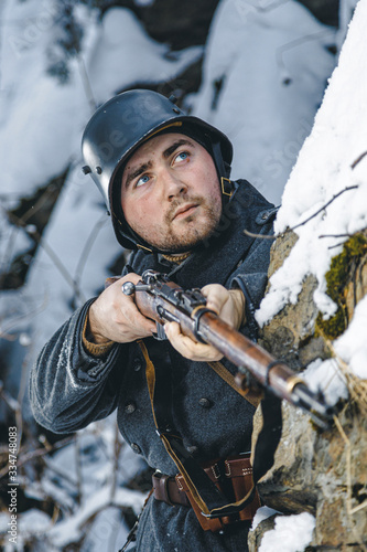 Obraz na plátně Soldier with a rifle in winter