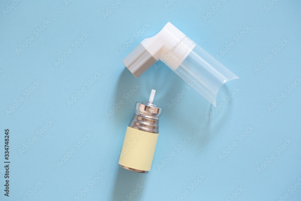 Inhaler on a blue background. The cure for asthma. Inhaler on a blue background. The cure for asthma.