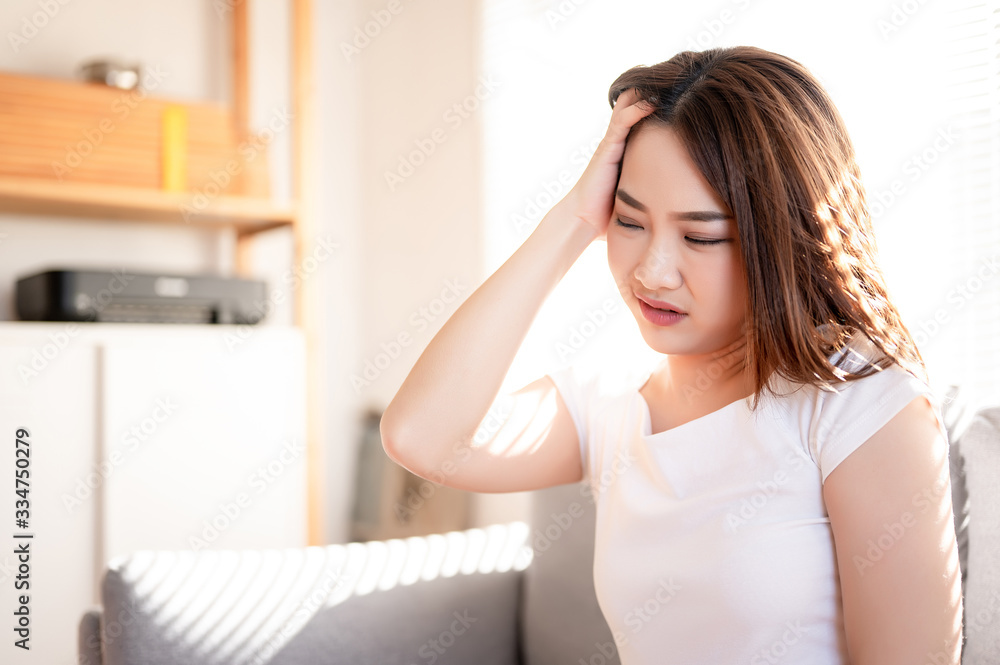 Sick woman with a hand on her head with sad disappointed, severe headache with a face torture she is ill, sick and flu. Stress, failure, problem, psychology and bad healthy concept.