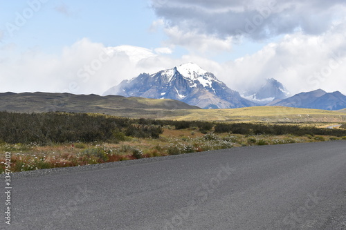 Street to Torres del Paine National Park in Chile, Patagonia with snow covered mountains in background