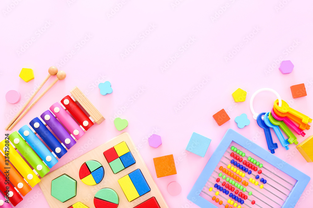 Colorful kids toys on pink background. Top view Colorful kids toys on pink background. Top view