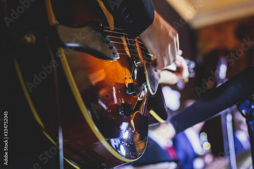 Photography Concert view of an electric guitar player with vocalist and musical jazz band or