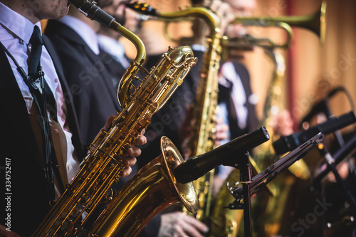 Photography Concert view of a saxophonist, saxophone player with vocalist and musical during