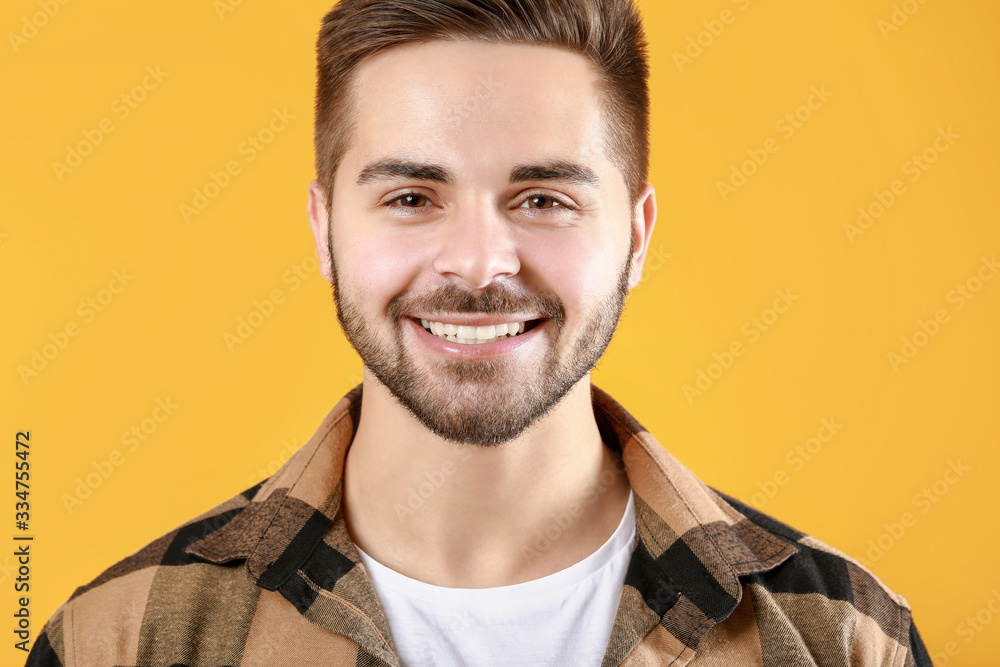 Handsome smiling young man on color background Handsome smiling young man on color background