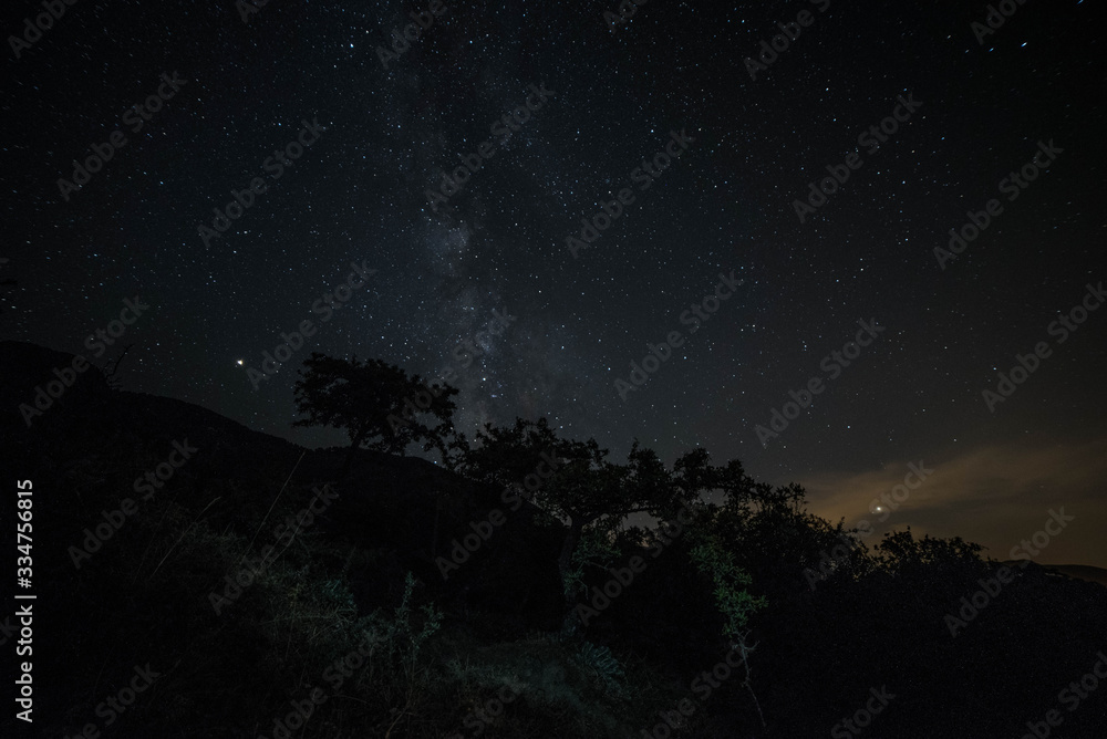 Colorful night landscape Milky Way over the mountains in the starry sky with hills in summer.