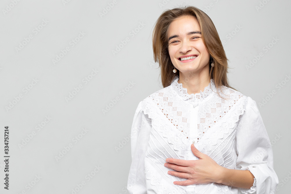 Beautiful young woman portrait. Studio shot, isolated on gray background Beautiful young woman portrait. Studio shot, isolated on gray background