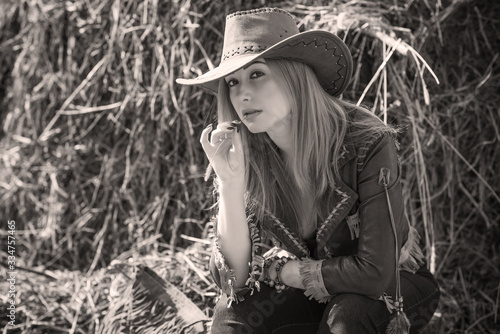 American style, girl in Leather cowboy jacket and hat, with nice modern figure and full hips 