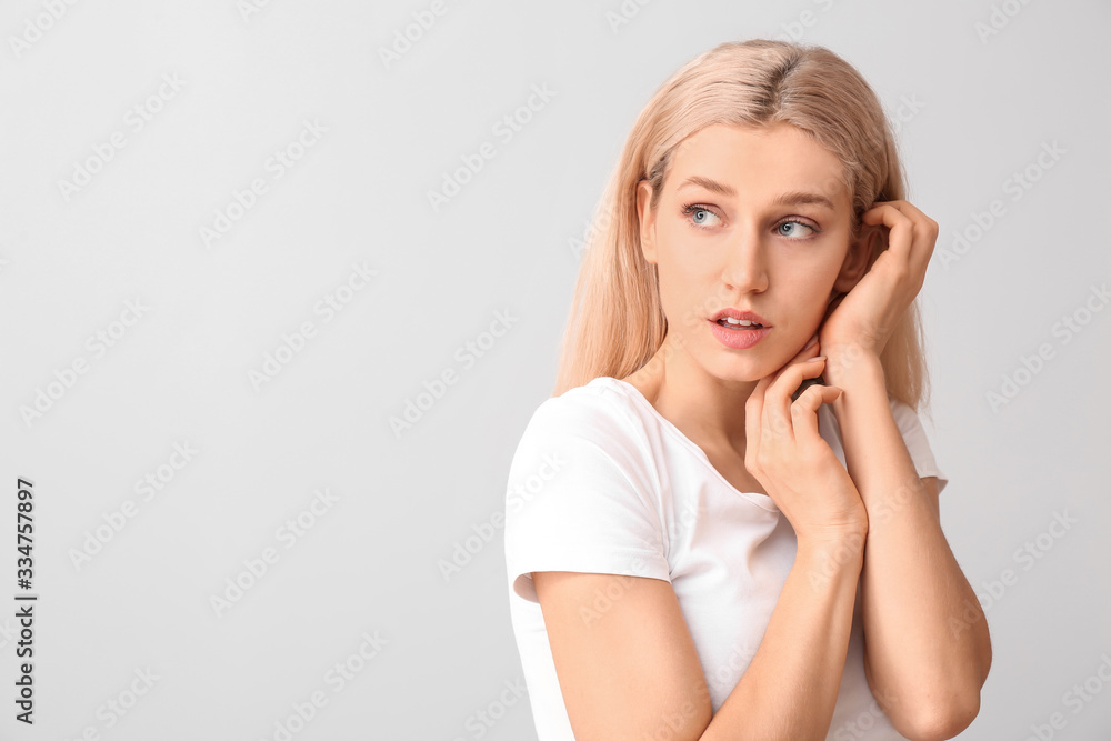 Young woman with beautiful makeup on light background Young woman with beautiful makeup on light background