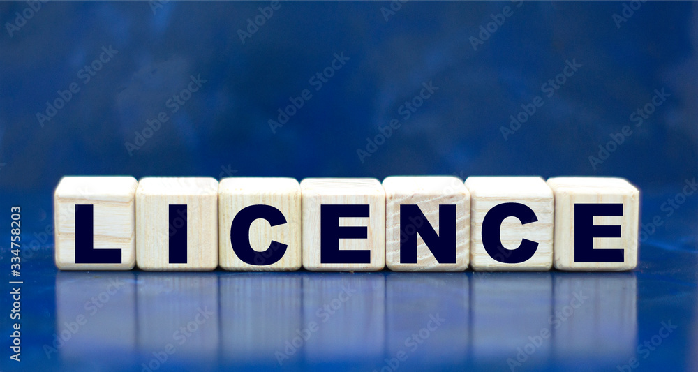 concept word LICENCE on cubes on a blue background